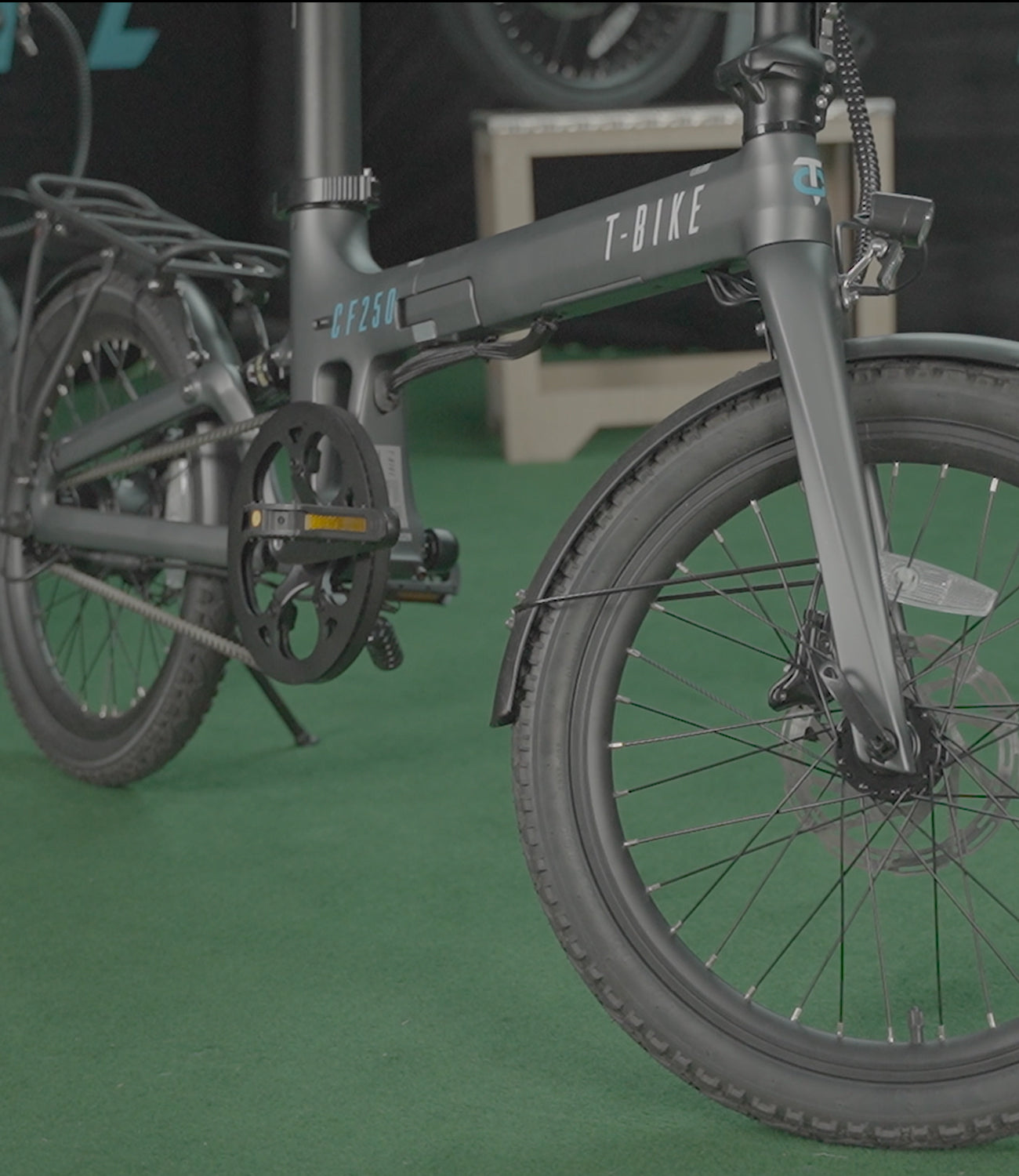 Image of the CF250 Folding carbon fibre E-Bike in matt gray in a showroom