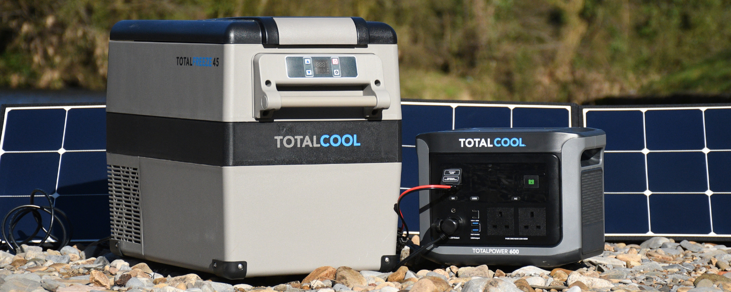 A portable camping fridge freezer and power supply