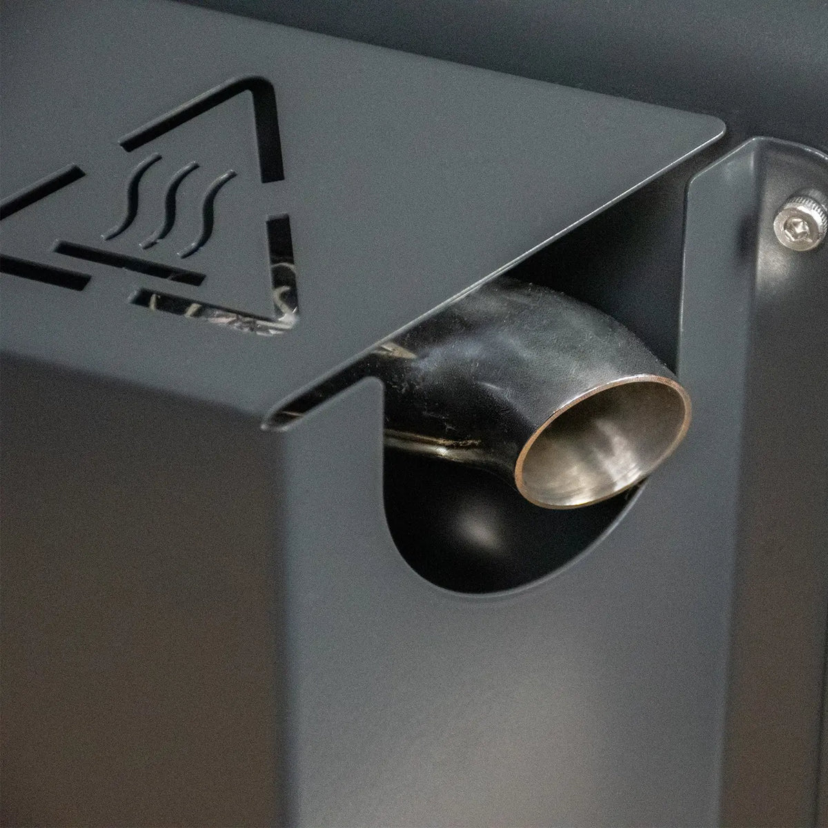 Close-up of a dark gray exhaust cover with a stainless steel curved exhaust.
