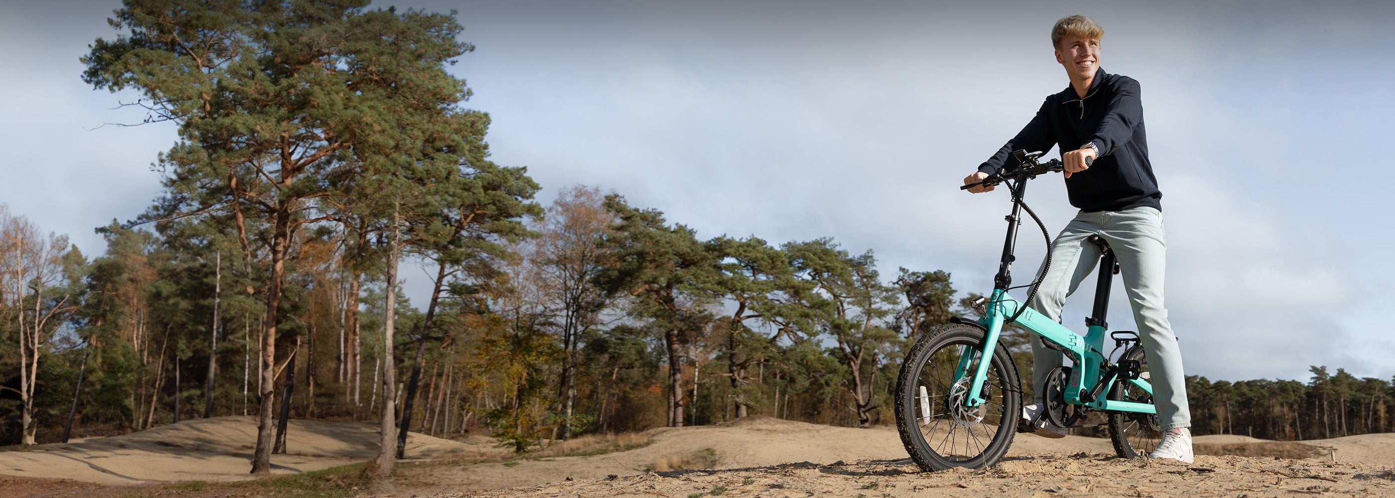 Image of a blonde man on a T-Bike outdoors