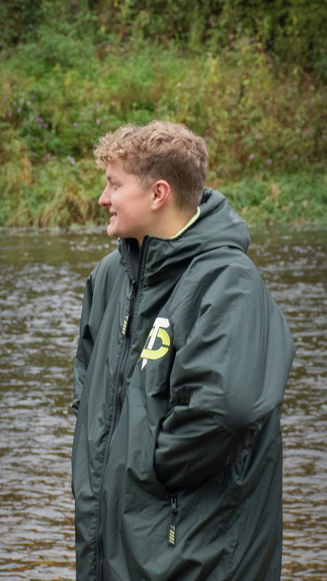 Image of man smiling wearing a T-Robe in front of a river