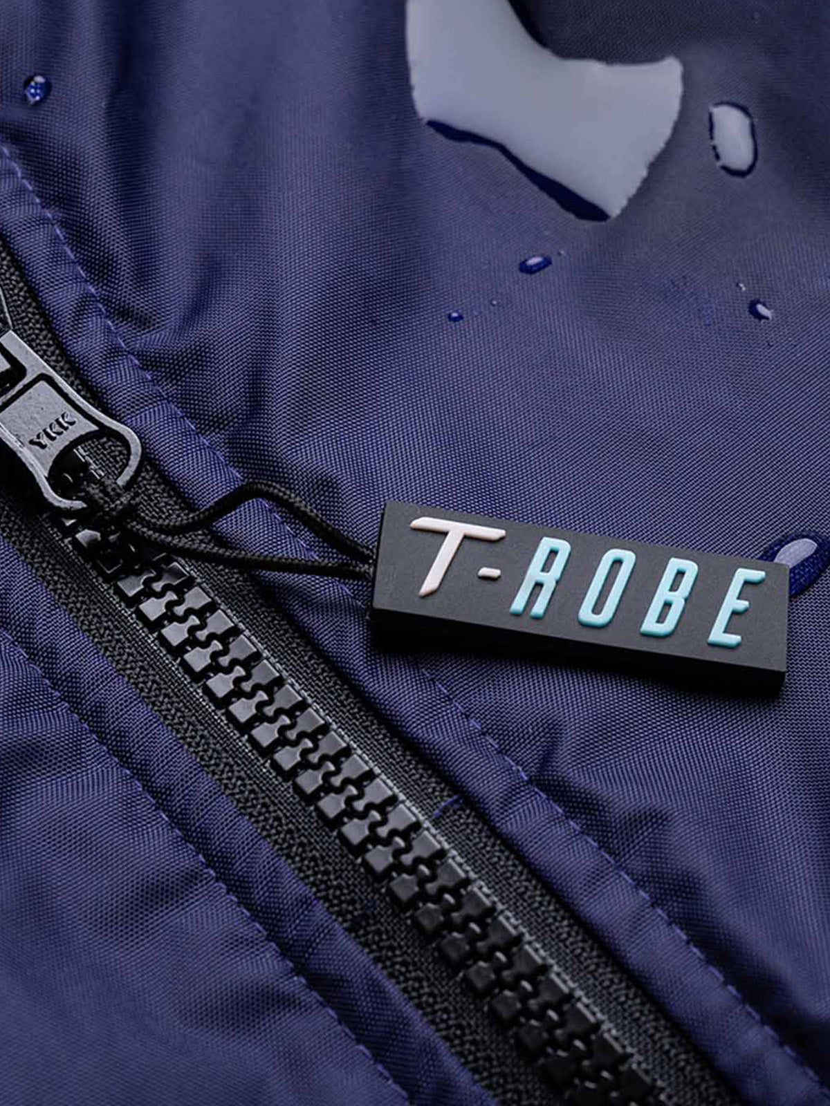 Close up image of the T-Robe with droplets of water on the surface, illustrating its waterproof capability