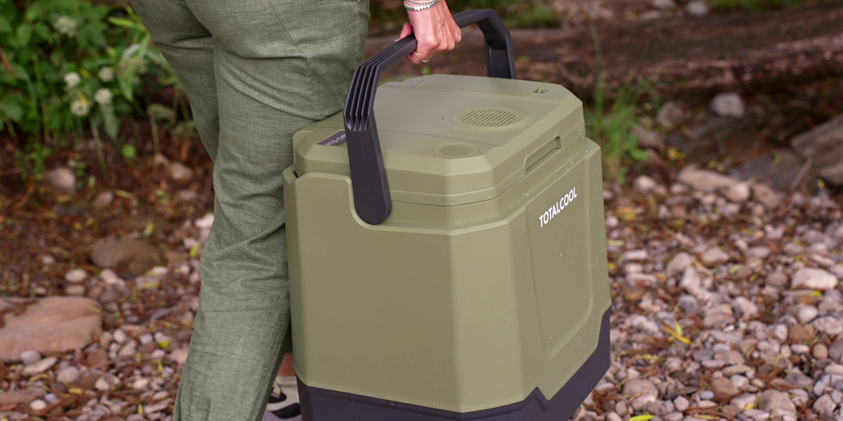 Image of the Eco-chill 33 green coolbox being carried for a picnic