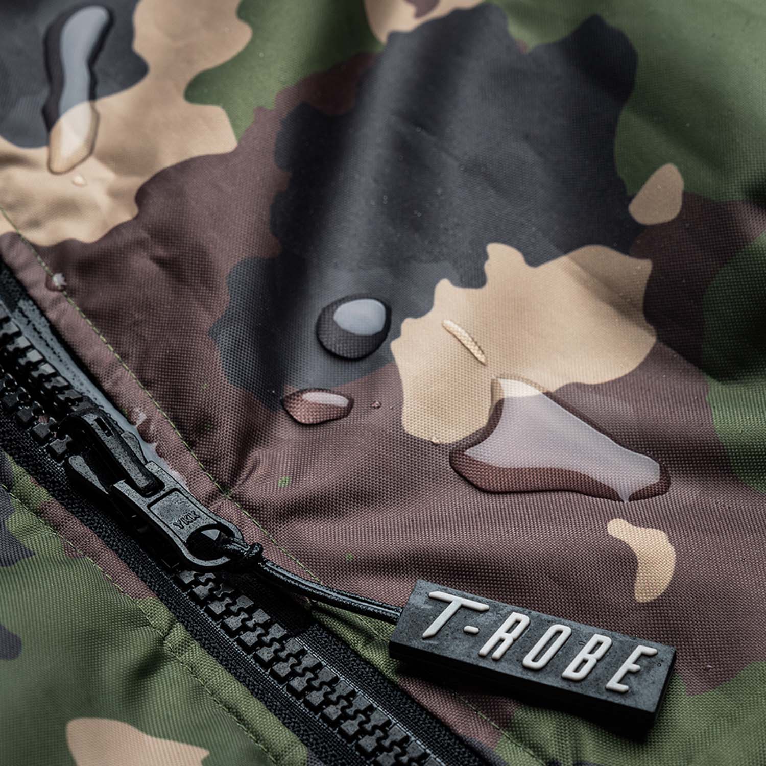 Image of water droplets on the surface of the camo and grey T-Robe showcasing the waterproof capabilities