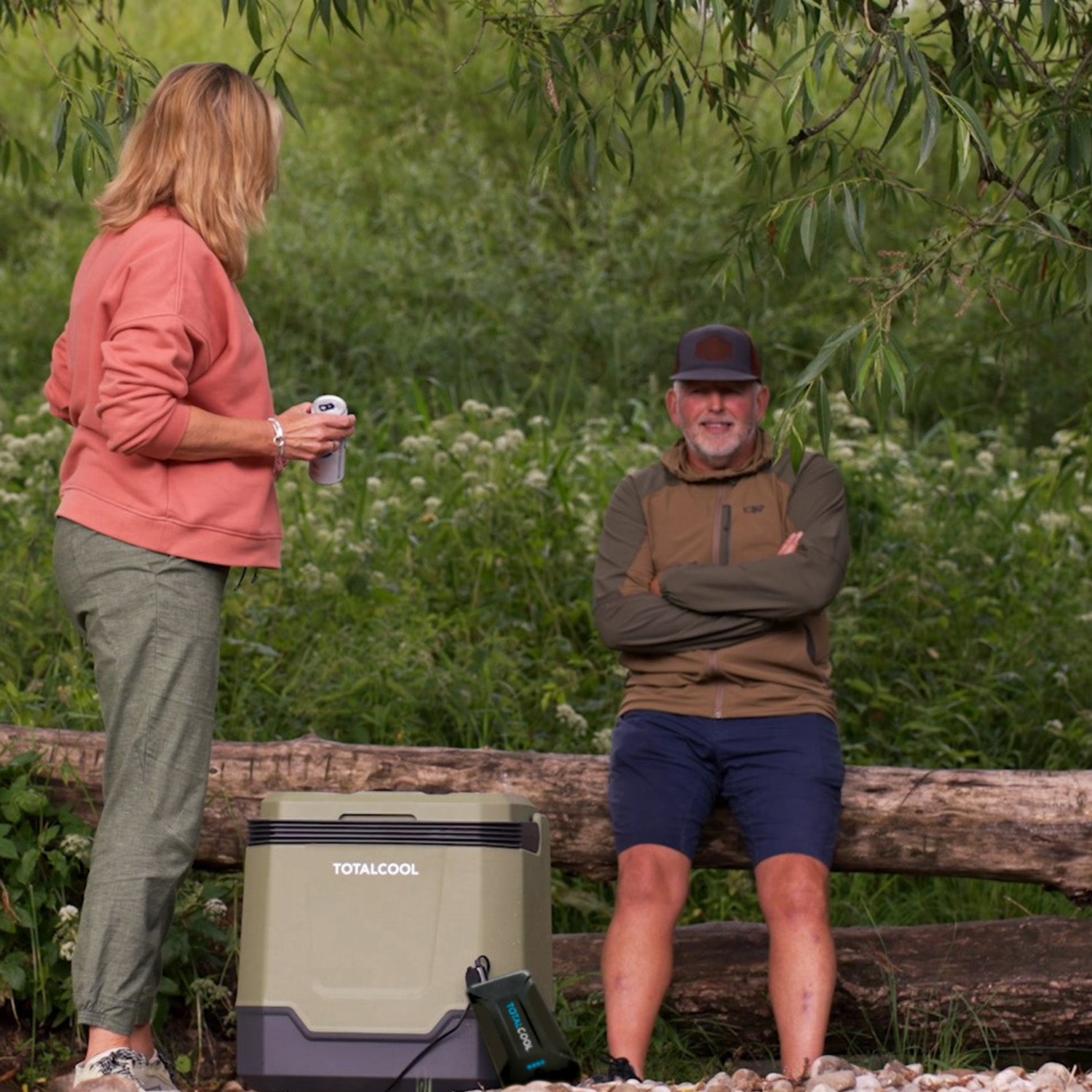 Image of a man and woman taking their Eco-Chill 33 Green coolbox on an outing whilst powering it with a TP144 