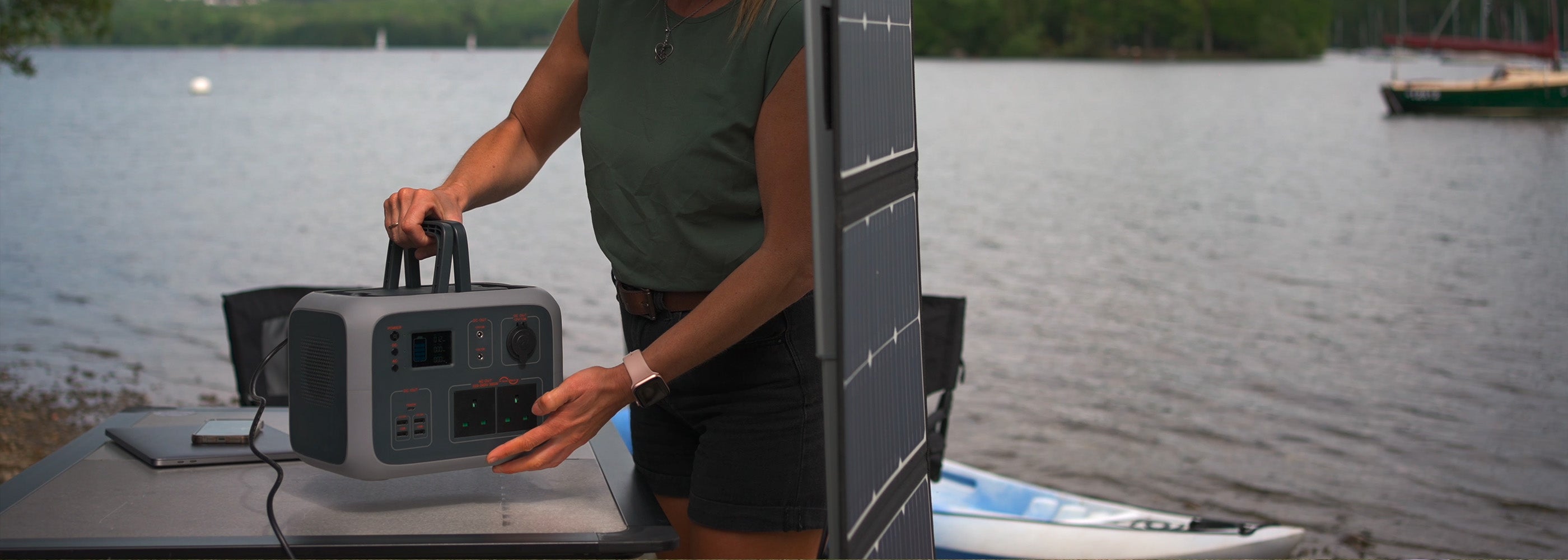 Image of the TP500 power bank being carried next to a TS100 solar panel outdoors