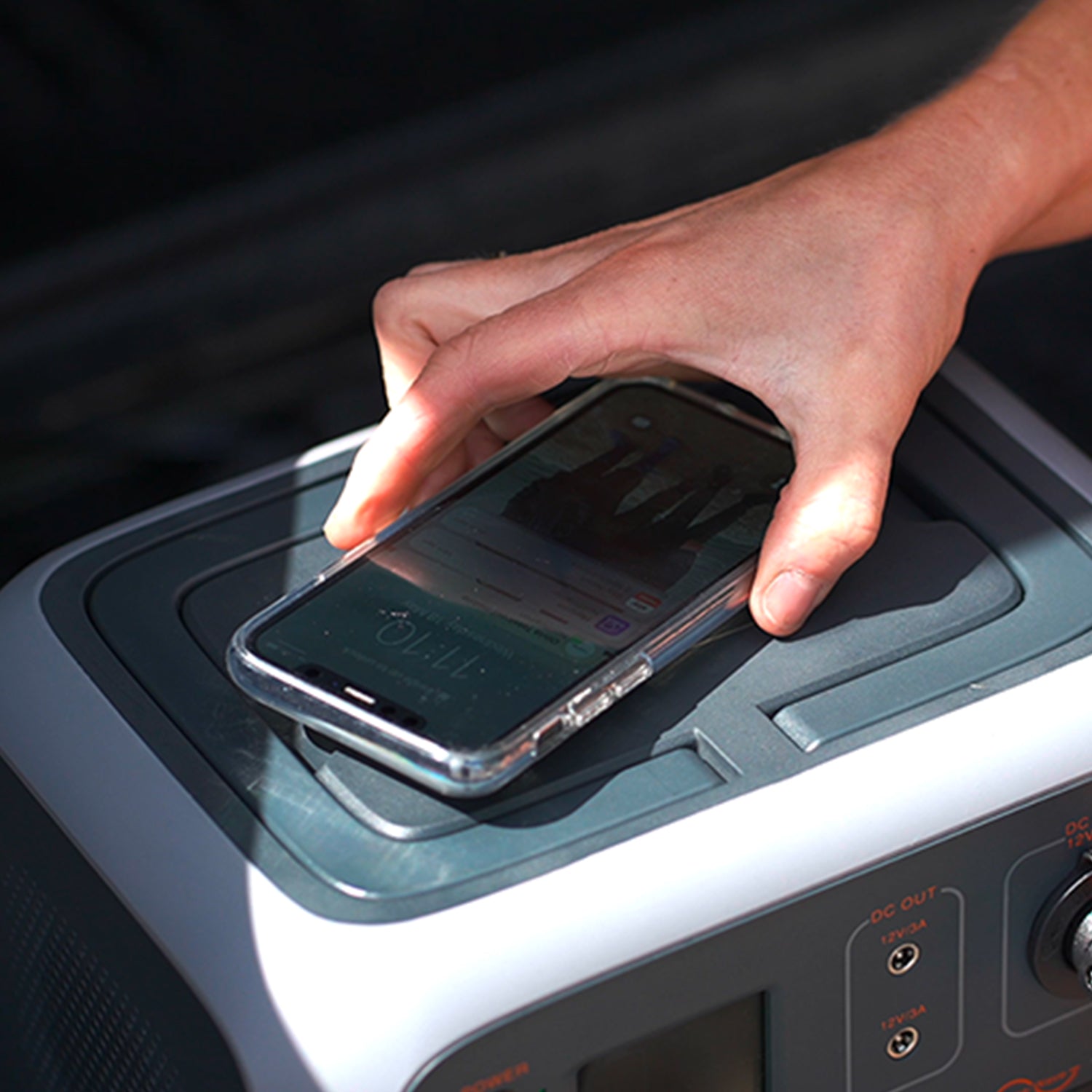 Image of a phone being charged via the wireless charging feature on the TP500 power bank